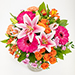 Geburtstagsblumen 5798 "Glanzleistung". Buntes, exotisches Bouquet in lebhaftem Orange und Pink mit Lilie, Nelken und Germini.